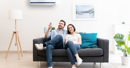 couple enjoying hvac system on couch