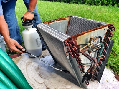 technician cleaning evaporator coil